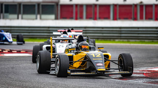 istock Men driving formula racing cars 1133992335