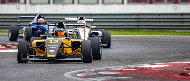 istock Men driving racing cars 1133992338