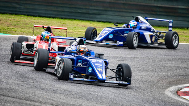 istock Men driving formula racing cars 1133992341