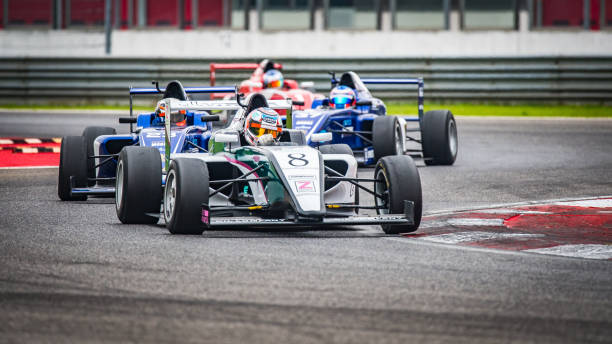 istock Men driving formula racing cars 1133992344