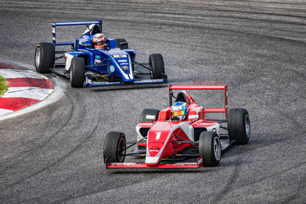 istock Men driving formula racing cars 1133992364