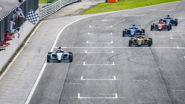 istock Men driving formula racing cars 1133992368