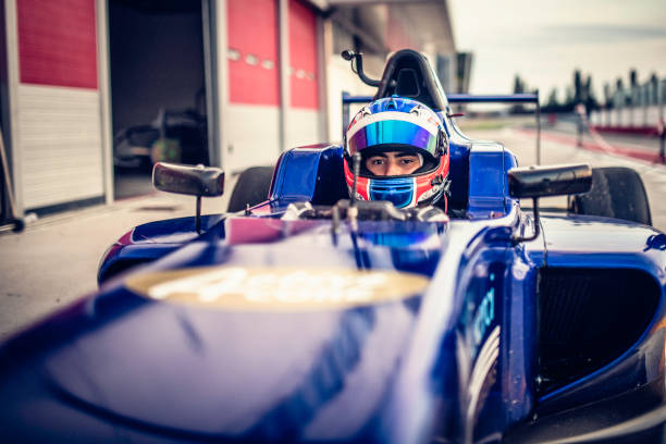 man driving formula racing car - blue helmets imagens e fotografias de stock