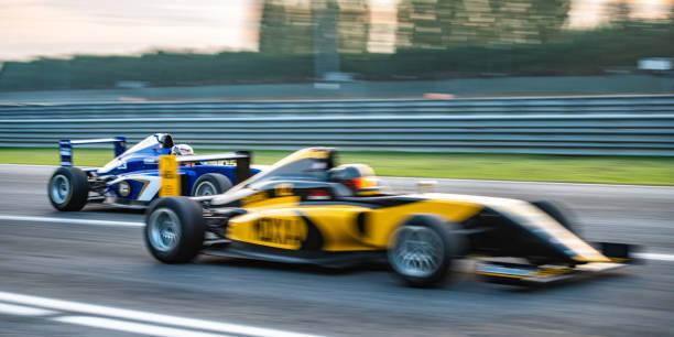 istock Men driving formula racing cars 1133992395