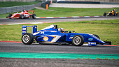 Man driving formula racing car