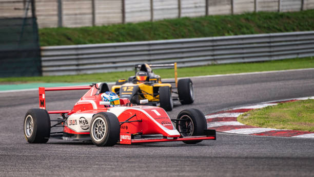 istock Men driving formula racing cars 1133992411