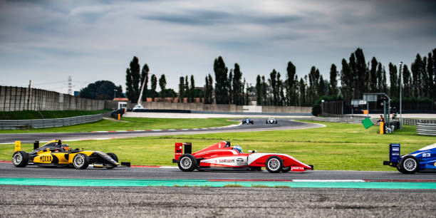 istock Men driving formula racing cars 1133992417
