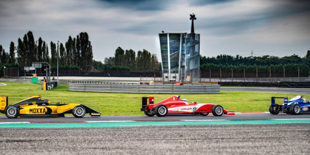 istock Men driving formula racing cars 1133992419