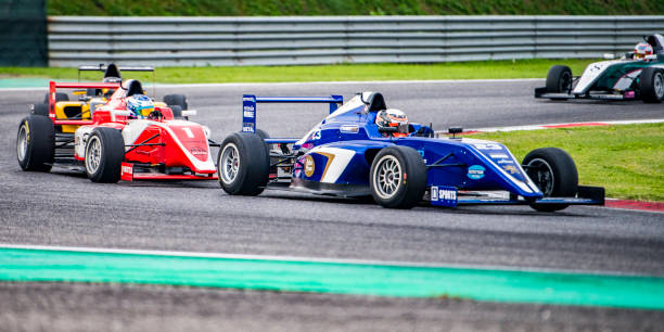 istock Men driving formula racing cars 1133992422