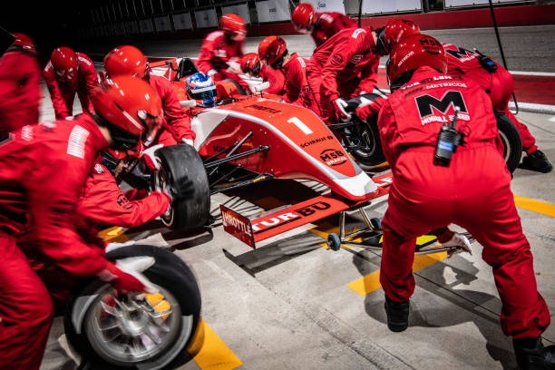 racing team working at pit stop - emotional stress looking group of people clothing imagens e fotografias de stock