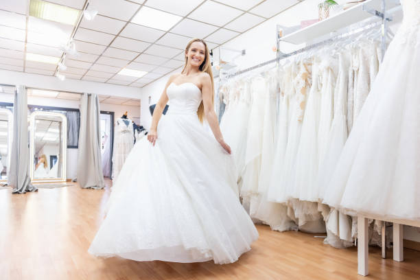 istock Smiling bride dancing in bridal shop 1133992537