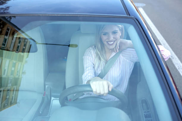 istock Attractive blonde girl observed through the windshield 1133993807