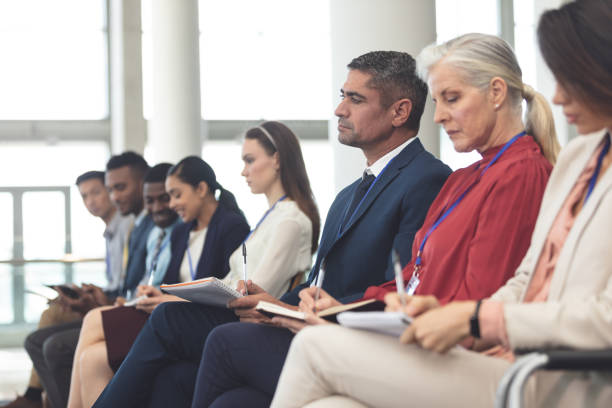 istock Business people writing on notepad in business seminar 1133997091