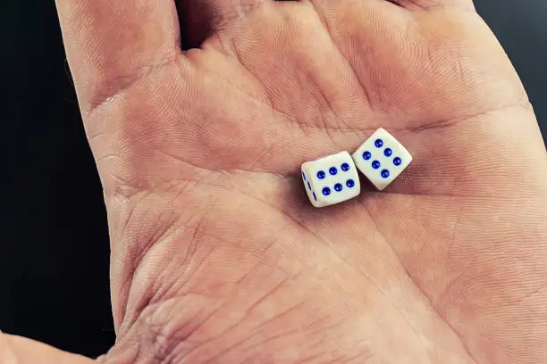 Photo of dice in a man's hand