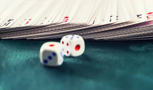 Photo of dice with cards on the table