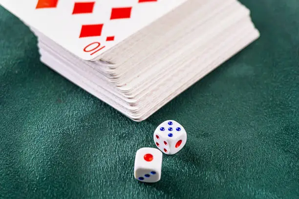 Photo of dice with cards on the table