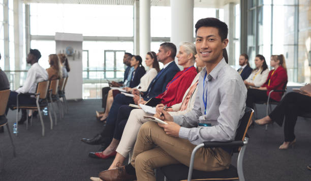 istock Happy businessman looking at camera in a seminar 1133997176
