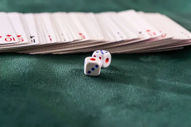 Photo of dice with cards on the table