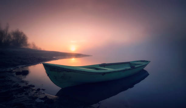 istock An old boat in lake on sunrise. 1133997213