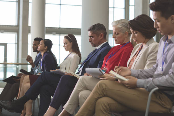 istock Business people writing on notepad in a business seminar 1133997391