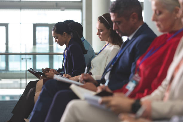 istock Business people writing on notepad in a business seminar 1133997433