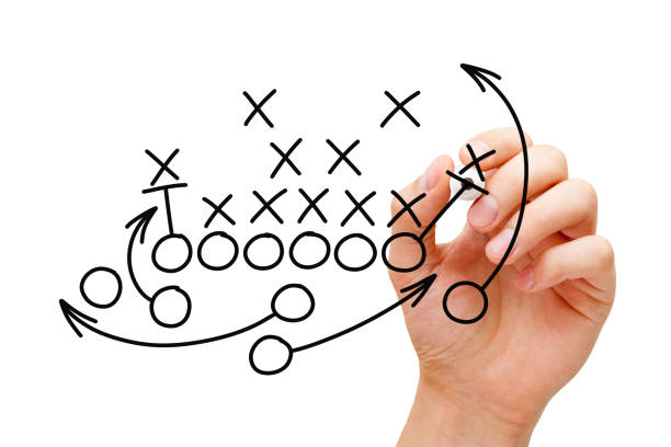 Coach Drawing American Football Playbook Strategy Coach drawing american football or rugby game playbook, tactics and strategy with black marker on white background. american football game plan stock pictures, royalty-free photos & images