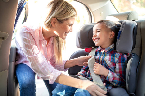 istock Responsible parent securing her child with a seatbelt 1133998391