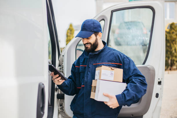 istock Delivery man with a parcel box in the car. - Stock image... Save 1133999202