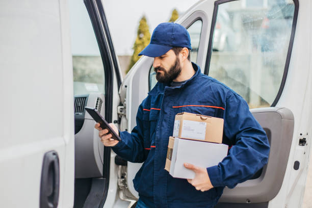 istock Delivery man with a parcel box in the car. - Stock image... Save 1133999224