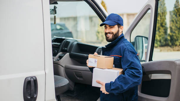istock Delivery man with a parcel box in the car. 1133999283