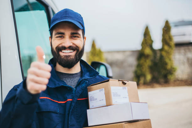 Portrait of a smiling deliverer We do same-day delivery for your convenience car portrait men expertise stock pictures, royalty-free photos & images