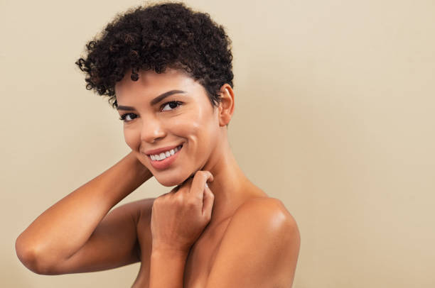 Beauty brazilian woman smiling Beautiful young woman touching her face skin and feel the softness with copy space. Smiling brazilian girl feeling skin face after beauty treatment. Portrait of cheerful african woman isolated on background looking at camera. good condition stock pictures, royalty-free photos & images