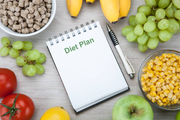 istock notebook with a diet plan with fresh vegetables and fruits on the table top view 1134000541