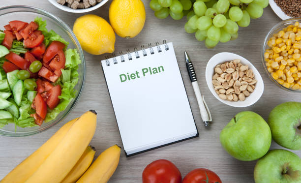 istock notebook with a diet plan with fresh vegetables and fruits on the table top view 1134000569