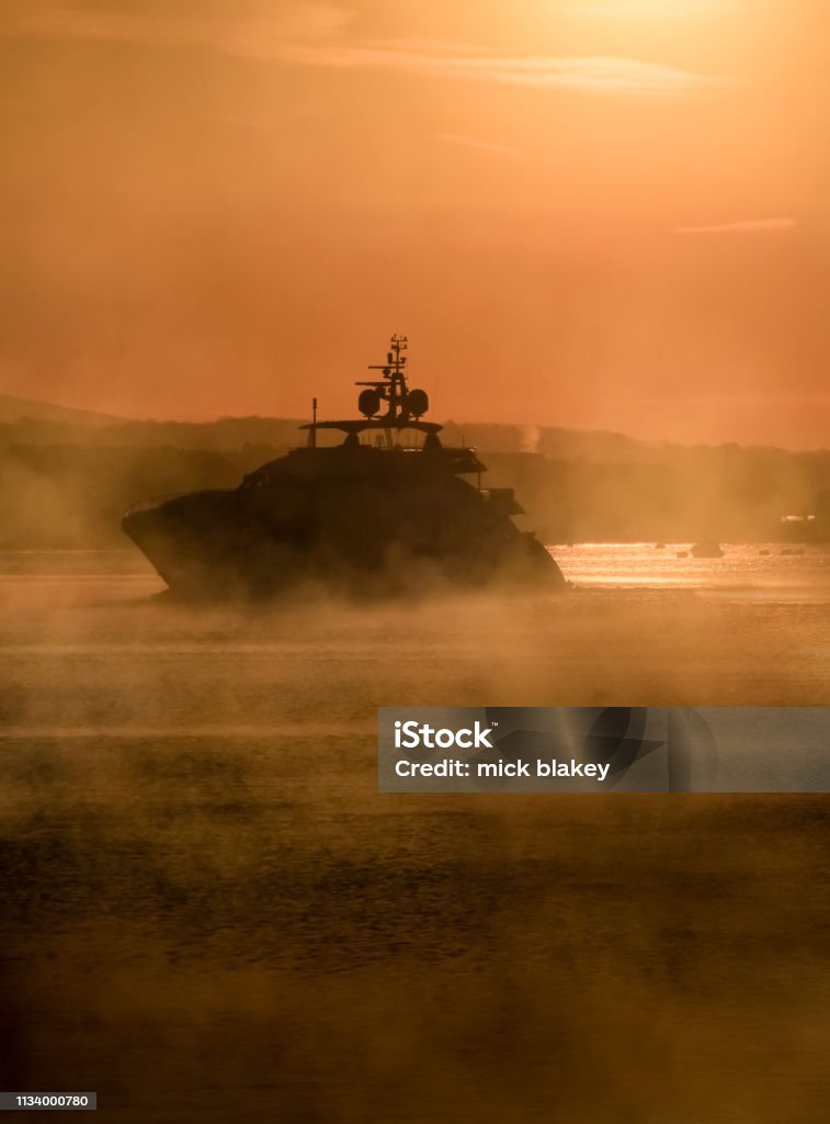 Motor Cruiser in Mist, Plymouth Sound, Devon Motor Cruiser in Mist, Plymouth Sound, South Devon, UK Cornwall - England Stock Photo