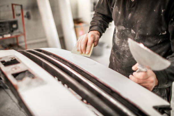 istock Using a small buffer to buff out excess paint on a car bumper that got damaged in a car accident. 1134001664
