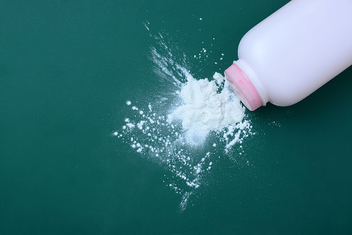 Baby talcum powder container on blue background with copy space