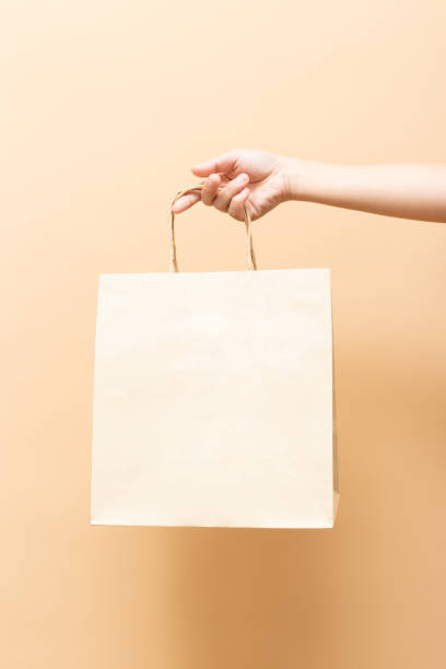 istock Hand holding a paper bag isolated on background 1134003172