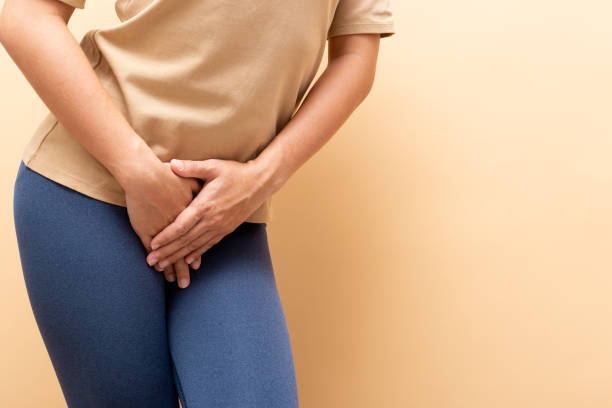 Closeup sick woman with hands holding pressing her crotch isolated on background Closeup sick woman with hands holding pressing her crotch isolated on background urinating stock pictures, royalty-free photos & images