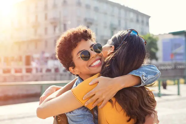 Photo of Two women hugging in town square