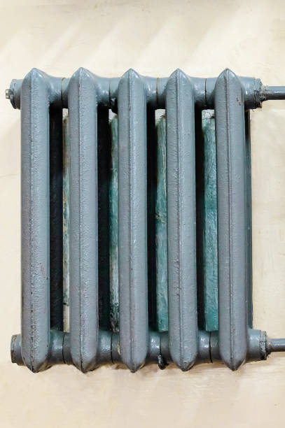 istock Cast-iron gray radiator for heating hanging on the wall. 1134003829