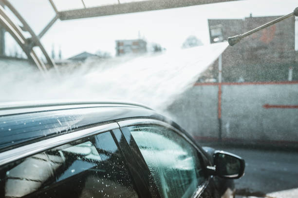 istock Man washing his car with high-pressure washing 1134005331