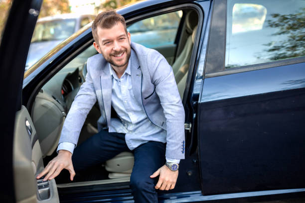 istock Charming young man getting out of his car 1134008614