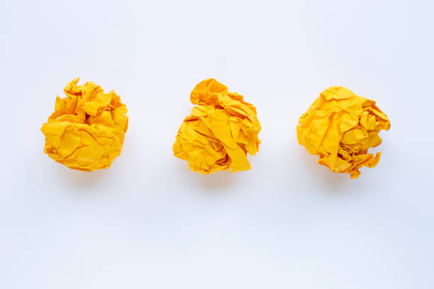 istock Yellow crumpled paper ball isolated on white 1134008652