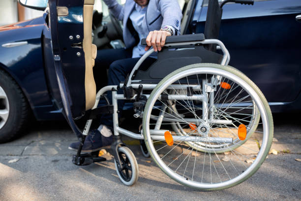 istock Young handicapped man reaching for his wheelchair 1134010123
