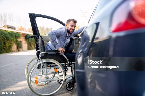 Handicapped Man Attempting To Get In The Car Stock Photo - Download Image Now - Car, Disability, Wheelchair