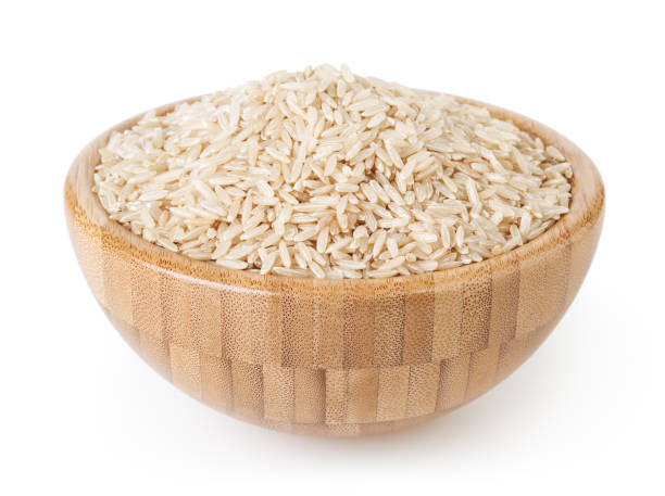 istock Brown rice in wooden bowl isolated on white background with clipping path 1134012257