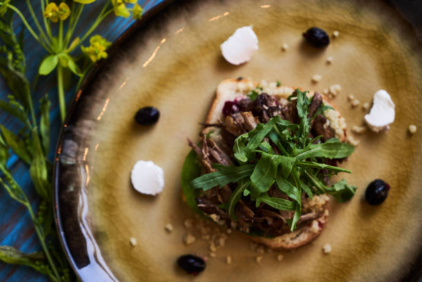 istock Breakfast toast bread with duck meat and quinoa, close-up. 1134013192