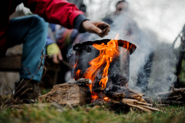 istock Man drawn by hand to the black pan standing on the bonfire 1134014755