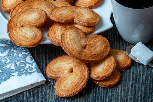 Palm cakes on dark background with mug and sugar